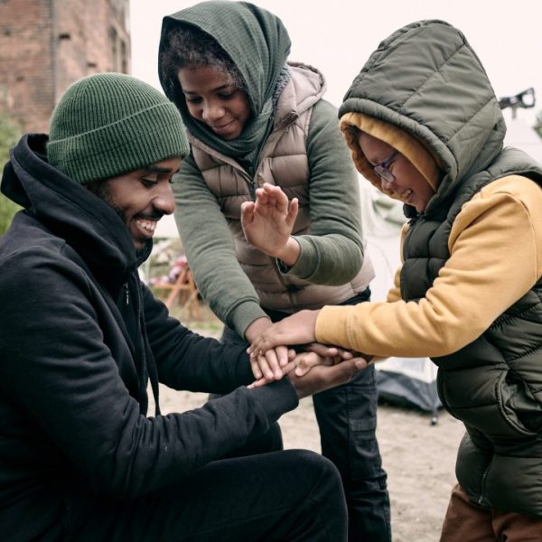 man-playing-with-kids-in-refugee-camp.jpg